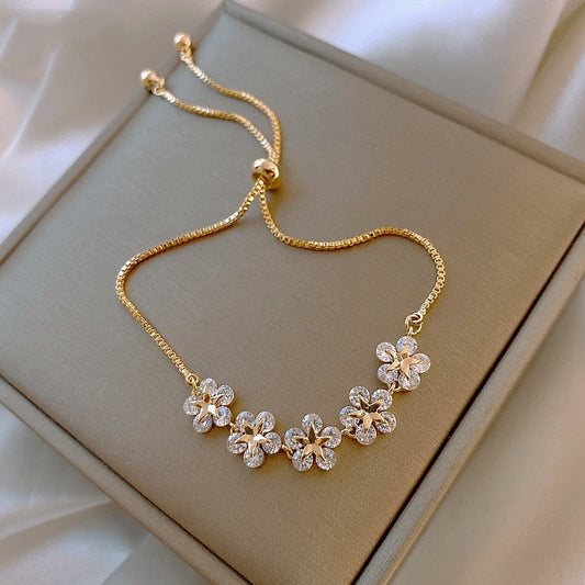Gold bracelet with flower crystals