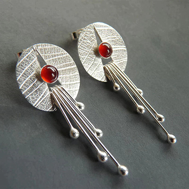 Dangling earrings with hollow red stone