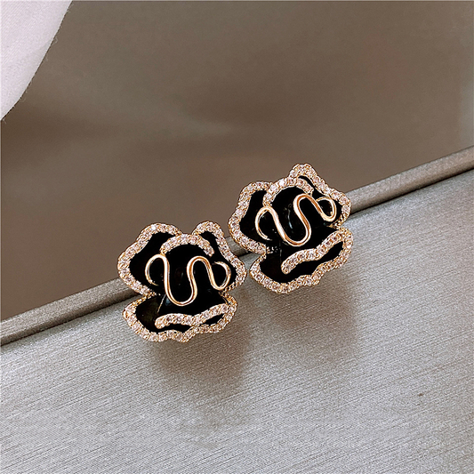 Elegant gold earrings with black lotus design